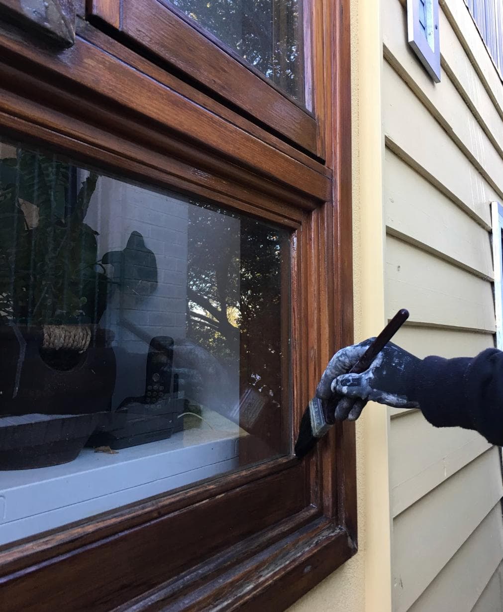 Hand-staining a wooden window frame